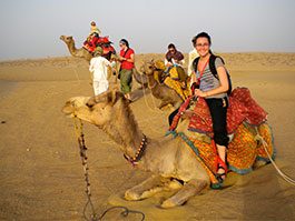 tourist with camel in desert